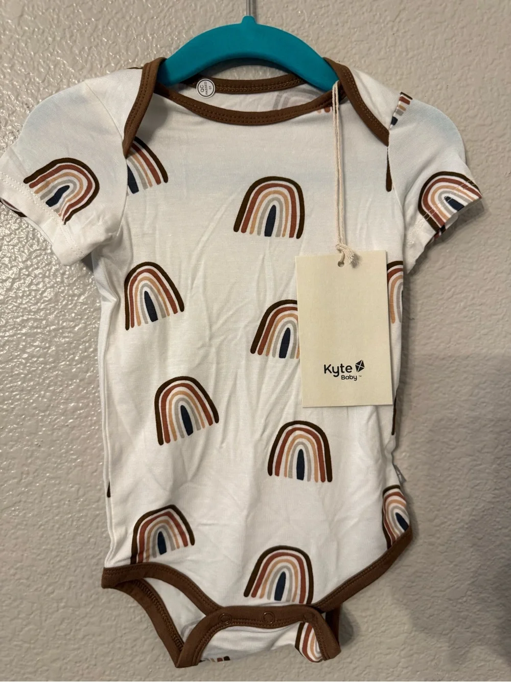 Kyte BABY Cream One-Piece with Brown Trim and Rainbow Print